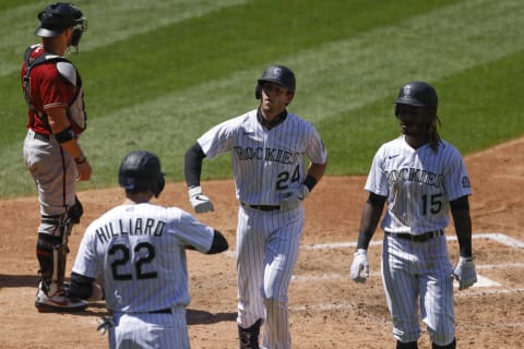 DENVER, CO – AUGUST 12: Ryan McMahon #24 of the Colorado Rockies is congratulated on his three-run home run by Sam Hilliard #22 and Raimel Tapia #15 during the fourth inning against the Arizona Diamondbacks at Coors Field on August 12, 2020 in Denver, Colorado. (Photo by Justin Edmonds/Getty Images)