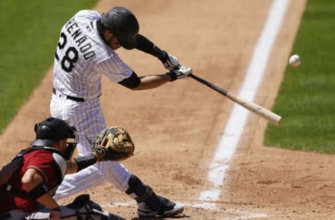 DENVER, CO – AUGUST 12: Nolan Arenado #28 of the Colorado Rockies hits a solo home run during the fifth inning against the Arizona Diamondbacks at Coors Field on August 12, 2020 in Denver, Colorado. (Photo by Justin Edmonds/Getty Images)