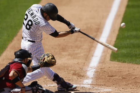 DENVER, CO – AUGUST 12: Nolan Arenado #28 of the Colorado Rockies hits a solo home run during the fifth inning against the Arizona Diamondbacks at Coors Field on August 12, 2020 in Denver, Colorado. (Photo by Justin Edmonds/Getty Images)