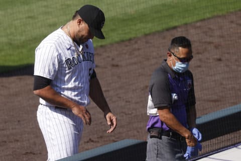 DENVER, CO – AUGUST 16: Relief pitcher Carlos Estevez #54 of the Colorado Rockies walks off the field with the medical staff after getting hit in the hand on a ground ball that ended the game in the ninth inning against the Texas Rangers at Coors Field on August 16, 2020 in Denver, Colorado. The Rockies defeated the Rangers 10-6. (Photo by Justin Edmonds/Getty Images)