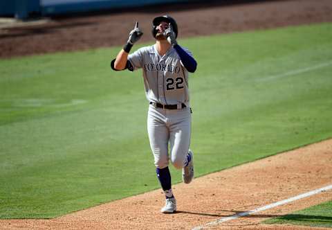 LOS ANGELES, CA – AUGUST 23: Sam Hilliard #22 of the Colorado Rockies celebrates on his way to the plate after hitting a solo home run against relief pitcher Dennis Santana of the Los Angeles Dodgers during the ninth inning at Dodger Stadium on August 23, 2020 in Los Angeles, California. (Photo by Kevork Djansezian/Getty Images)