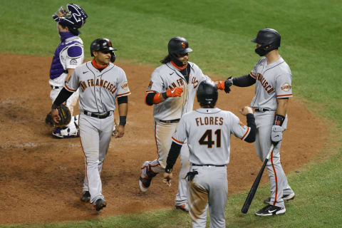 DENVER, CO – SEPTEMBER 01: Brandon Crawford #35 of the San Francisco Giants (C) is congratulated by Donovan Solano #7 (2L), Wilmer Flores #41 and Joey Bart #21 as catcher Tony Wolters #14 of the Colorado Rockies kneels behind the plate during the sixth inning at Coors Field on September 1, 2020 in Denver, Colorado. (Photo by Justin Edmonds/Getty Images)