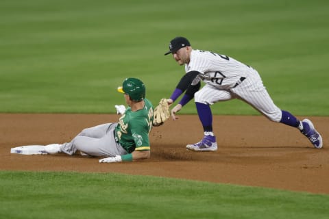 DENVER, CO – SEPTEMBER 15: Jake Lamb #4 of the Oakland Athletics slides in safely with a double ahead of the tag by Trevor Story #27 of the Colorado Rockies during the fourth inning at Coors Field on September 15, 2020 in Denver, Colorado. (Photo by Justin Edmonds/Getty Images)