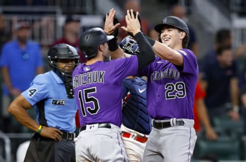 ATLANTA, GA - AUGUST 31: Michael Toglia #29 reacts with Randal Grichuk #15 of the Colorado Rockies after hitting a two run home run during the ninth inning against the Atlanta Braves at Truist Park on August 31, 2022 in Atlanta, Georgia. (Photo by Todd Kirkland/Getty Images)