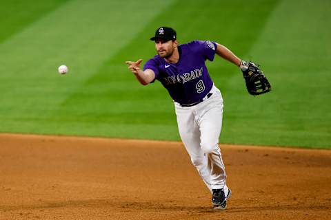 DENVER, CO – AUGUST 10: Daniel Murphy #9 of the Colorado Rockies tosses the ball towards first base during the ninth inning against the Arizona Diamondbacks at Coors Field on August 10, 2020 in Denver, Colorado. The Diamondbacks defeated the Rockies 12-8. (Photo by Justin Edmonds/Getty Images)