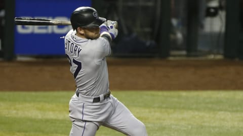 PHOENIX, ARIZONA – SEPTEMBER 26: Trevor Story #27 of the Colorado Rockies follows through on his swing after hitting a single against the Arizona Diamondbacks during the seventh inning of the MLB game at Chase Field on September 26, 2020 in Phoenix, Arizona. (Photo by Ralph Freso/Getty Images)