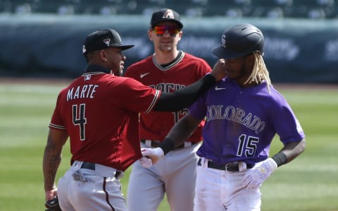 SCOTTSDALE, ARIZONA – FEBRUARY 28: Raimel Tapia #15 of the Colorado Rockies tugs on the jersey of infielder Ketel Marte #4 of the Arizona Diamondbacks as Marte admires Tapia’s new hair style during the third inning of the Cactus League spring training baseball game on February 28, 2021 in Scottsdale, Arizona. (Photo by Ralph Freso/Getty Images)