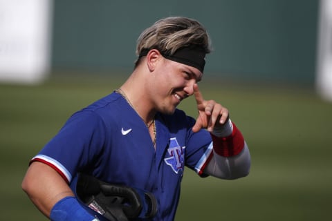 SURPRISE, ARIZONA – MARCH 07: Steele Walker #74 of the Texas Rangers waves to a fan as he walks off the field during the eighth inning of the MLB spring training baseball game against the Los Angels Dodgers at Surprise Stadium on March 07, 2021 in Surprise, Arizona. (Photo by Ralph Freso/Getty Images)