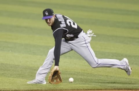 MIAMI, FLORIDA – JUNE 08: Ryan McMahon #24 of the Colorado Rockies fields a ground ball against the Miami Marlins during the first inning at loanDepot park on June 08, 2021 in Miami, Florida. (Photo by Michael Reaves/Getty Images)