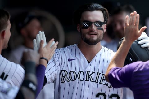 DENVER, COLORADO – AUGUST 05: Sam Hilliard #22 of the Colorado Rockies celebrates in the dugout after hitting a solo home run against the Chicago Cubs in the fourth inning at Coors Field on August 05, 2021 in Denver, Colorado. (Photo by Matthew Stockman/Getty Images)