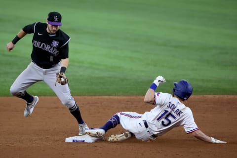 ARLINGTON, TEXAS – AUGUST 31: Garrett Hampson #1 of the Colorado Rockies tags out Nick Solak #15 of the Texas Rangers at second base in the bottom of the third inning at Globe Life Field on August 31, 2021 in Arlington, Texas. (Photo by Tom Pennington/Getty Images)