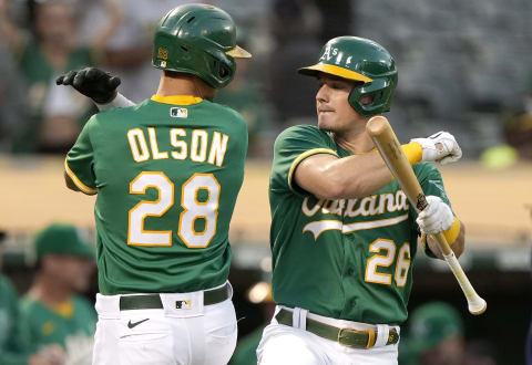 OAKLAND, CALIFORNIA – SEPTEMBER 21: Matt Olson #28 and Matt Chapman #26 of the Oakland Athletics celebrates after Olson hit a solo home run against the Seattle Mariners in the bottom of the first inning at RingCentral Coliseum on September 21, 2021 in Oakland, California. (Photo by Thearon W. Henderson/Getty Images)