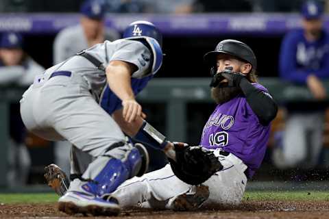 DENVER, COLORADO – SEPTEMBER 22: Charlie Blackmon #19 of the Colorado Rockies scores against catcher Will Smith #16 of the Los Angeles Dodgers on a C.J. Cron double in the seventh inning at Coors Field on September 22, 2021 in Denver, Colorado. (Photo by Matthew Stockman/Getty Images)