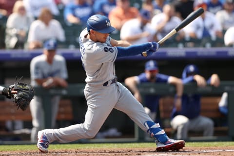 DENVER, COLORADO – SEPTEMBER 23: Austin Barnes #15 of the Los Angeles Dodgers hits a RBI single against the Colorado Rockies in the second inning at Coors Field on September 23, 2021 in Denver, Colorado. (Photo by Matthew Stockman/Getty Images)