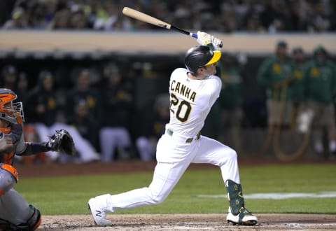 OAKLAND, CALIFORNIA – SEPTEMBER 24: Mark Canha #20 of the Oakland Athletics hits a sacrifice fly scoring Starling Marte #2 against the Houston Astros in the bottom of the third inning at RingCentral Coliseum on September 24, 2021 in Oakland, California. (Photo by Thearon W. Henderson/Getty Images)