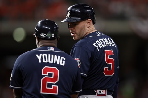 HOUSTON, TEXAS – OCTOBER 27: Freddie Freeman #5 of the Atlanta Braves speaks to Eric Young Sr. after hitting a single against the Houston Astros during the fifth inning in Game Two of the World Series at Minute Maid Park on October 27, 2021 in Houston, Texas. (Photo by Patrick Smith/Getty Images)