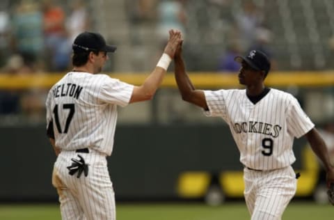 DENVER – AUGUST 8: First baseman Todd Helton #17 of the Colorado Rockies congratulates center fielder Juan Pierre #9 after winning the MLB game against the Cincinnati Reds on August 8, 2002 at Coors Field in Denver, Colorado. The Rockies won 10-3. (Photo by Brian Bahr/Getty Images)