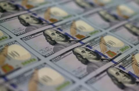 WASHINGTON, DC – MAY 20: Newly redesigned $100 notes lay in stacks at the Bureau of Engraving and Printing on May 20, 2013 in Washington, DC. The one hundred dollar bills will be released this fall and has new security features, such as a duplicating portrait of Benjamin Franklin and microprinting added to make the bill more difficult to counterfeit. (Photo by Mark Wilson/Getty Images)