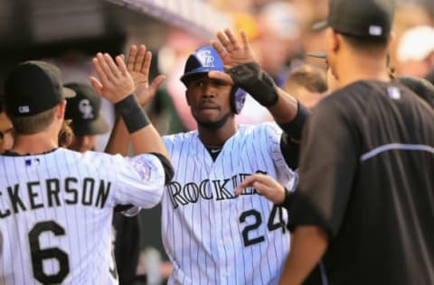 DENVER, CO – AUGUST 09: Dexter Fowler #24 of the Colorado Rockies celebrates in the dugout after scroing against the Pittsburgh Pirates at Coors Field on August 9, 2013 in Denver, Colorado. The Rockies defeated the Pirates 10-1. (Photo by Doug Pensinger/Getty Images)