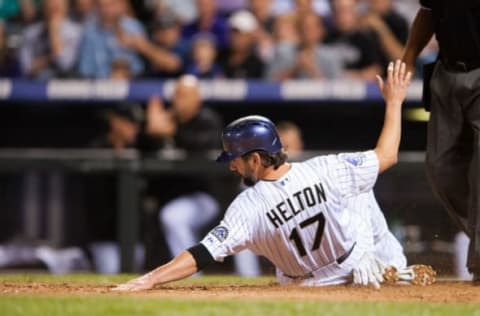 DENVER, CO – SEPTEMBER 18: Todd Helton #17 of the Colorado Rockies slides across home plate to score from second base in the sixth inning of a game against the St. Louis Cardinals at Coors Field on September 18, 2013 in Denver, Colorado. (Photo by Dustin Bradford/Getty Images)