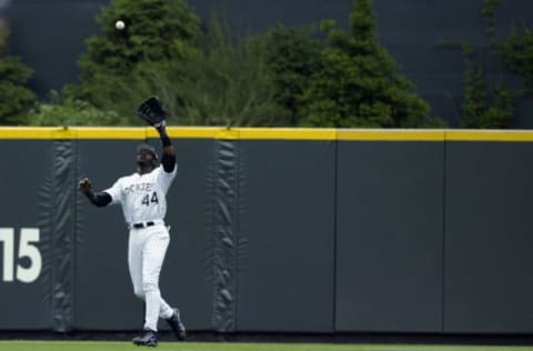 DENVER – MAY 24: Preston Wilson #44 of the Colorado Rockies fields a fly ball in the outfield during the game against the San Francisco Giants at Coors Field on May 24, 2003 in Denver, Colorado. The Giants defeated the Rockies 5-1. (Photo by Brian Bahr/Getty Images)