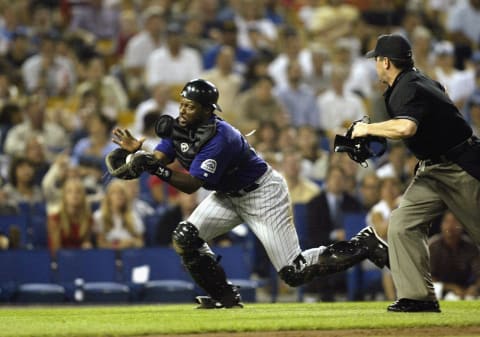 LOS ANGELES – JULY 23: Catcher Charles Johnson #23 of the Colorado Rockies catches a pop-up from a botched bunt attempt by Kazuhisa Ishii #17 of the Los Angeles Dodgers during their game on July 23, 2003 at Dodger Stadium in Los Angeles, California. (Photo by Jeff Gross/Getty Images)