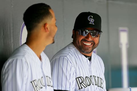 DENVER, CO – JULY 26: Special Assistant Vinny Castilla shares a laugh with Carlos Gonzalez #5 of the Colorado Rockies in the dugout during a game against the Cincinnati Reds at Coors Field on July 26, 2015 in Denver, Colorado. The Rockies defeated the Reds 17-7. (Photo by Justin Edmonds/Getty Images)