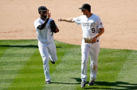 DENVER, CO – SEPTEMBER 01: Shortstop Jose Reyes #7 of the Colorado Rockies and second baseman DJ LeMahieu #9 of the Colorado Rockies celebrate after they teamed up with Ben Paulsen #10 of the Colorado Rockies for a triple play on a line drive by Paul Goldschmidt #44 of the Arizona Diamondbacks in the ninth inning at Coors Field on September 1, 2015 in Denver, Colorado. The Diamondbacks defeated the Rockies 6-4. (Photo by Doug Pensinger/Getty Images)