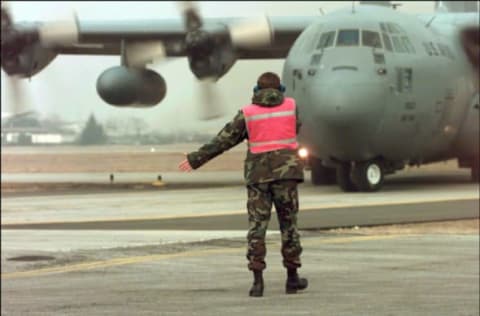 Crew Chief Rick Kell, Directs A C-130 Aircraft From The 37Th Airlift Squadron, Ramstein Air Base, Germany, February 22, 1999 Landing At Aviano Air Force Base In Italy. The Ramstein Aircrews Are Transporting Personnel And Equipment To Aviano And Other European Areas In Support Of Kosovo-Related Nato Operations. (Photo By Usaf/Getty Images)