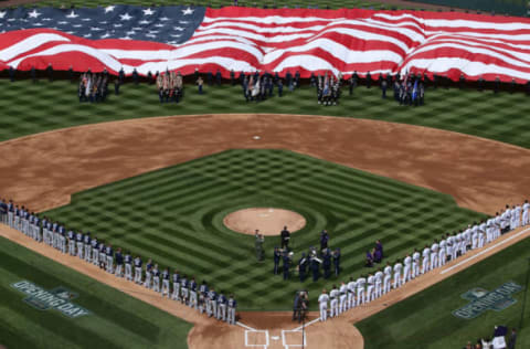 DENVER, COLORADO – APRIL 08: The American Flag is unfurled as the national anthem is observed prior to the San Diego Padres facing the Colorado Rockies during opening day at Coors Field on April 8, 2016 in Denver, Colorado. (Photo by Doug Pensinger/Getty Images)