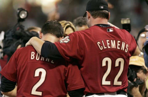 HOUSTON - OCTOBER 09: Winning pitcher Roger Clemens #22 of the Houston Astros puts his arm around Chris Burke #2 after Burke hit a solo home run to defeat the Atlanta Braves in Game Four of the 2005 National League Division Series on October 9, 2005 at Minute Maid Park in Houston, Texas. The Astros eliminated the Braves three games to one with a 7-6 victory in the 18th inning. (Photo by Doug Benc/Getty Images)