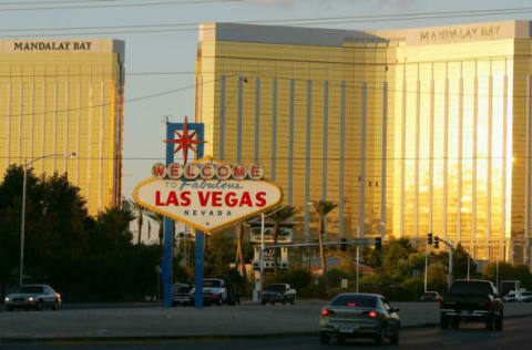 LAS VEGAS – NOVEMBER 11: Traffic passes by the famous sign welcoming motorists on the south end of the Las Vegas Strip November 11, 2005 in Las Vegas, Nevada. The Mandalay Bay Resort & Casino is in the background. (Photo by Ethan Miller/Getty Images)