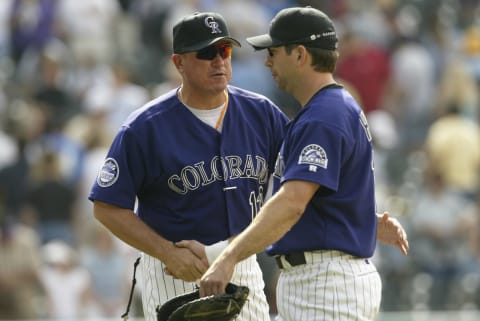 DENVER – MAY 18: Manager Clint Hurdle #13 of the Colorado Rockies congratulates first baseman Todd Helton #17 after winning the MLB game against the Atlanta Braves at Coors Field in Denver, Colorado on May 18, 2002. The Rockies beat the Braves 7-3. (Photo by Brian Bahr/Getty Images).