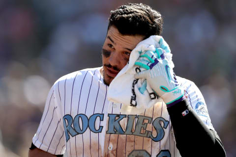 DENVER, CO – JUNE 18: Nolan Arenado #28 of the Colorado Rockies wipes his forehead after sustaining a cut while celebrating hitting a 3 RBI walk off home run in the ninth inning against the San Francisco Giants at Coors Field on June 18, 2017 in Denver, Colorado. (Photo by Matthew Stockman/Getty Images)