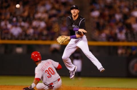 DENVER, CO – JULY 5: Trevor Story #27 of the Colorado Rockies leaps over Arismendy Alcantara #30 of the Cincinnati Reds to complete a double play during the ninth inning at Coors Field on July 5, 2017 in Denver, Colorado. The Rockies defeated the Reds 5-3. (Photo by Justin Edmonds/Getty Images)