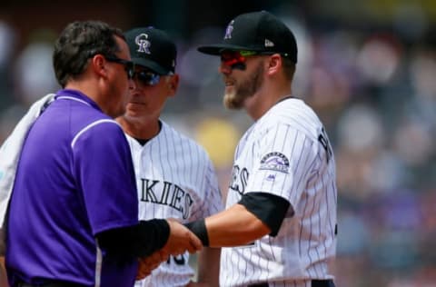 DENVER, CO – AUGUST 20: First baseman Mark Reynolds #12 of the Colorado Rockies is looked at by the trainer after injuring himself on a play during the fourth inning as Manager Bud Black of the Colorado Rockies looks on against the Milwaukee Brewers at Coors Field on August 20, 2017 in Denver, Colorado. (Photo by Justin Edmonds/Getty Images)