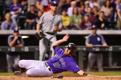 DENVER, CO – SEPTEMBER 15: Mark Reynolds #12 of the Colorado Rockies slides past home plate as he scores a run against the San Diego Padres int he second inning of a game at Coors Field on September 15, 2017 in Denver, Colorado. (Photo by Dustin Bradford/Getty Images)