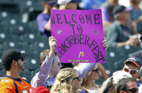 DENVER, CO – OCTOBER 01: A Rockies fan holds up a sign about the post season prior to a regular season MLB game between the Colorado Rockies and the visiting Los Angeles Dodgers at Coors Field on October 1, 2017 in Denver, Colorado. (Photo by Russell Lansford/Getty Images)