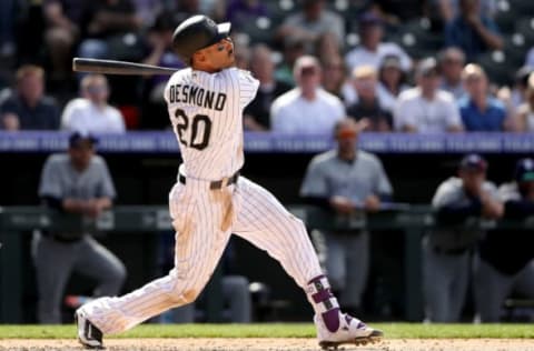 DENVER, CO – APRIL 11: Ian Desmond #20 of the Colorado Rockies hits a RBI sacrifice fly the sixth inning against the San Diego Padres at Coors Field on April 11, 2018 in Denver, Colorado. (Photo by Matthew Stockman/Getty Images)