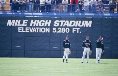 DENVER – APRIL 15: Colorado Rockies players stand in the outfield with at Mile High Stadium elevation sign in background before the game against the New York Mets on April 15, 1993 in Denver, Colorado. (Photo by Tim DeFrisco/Getty Images)