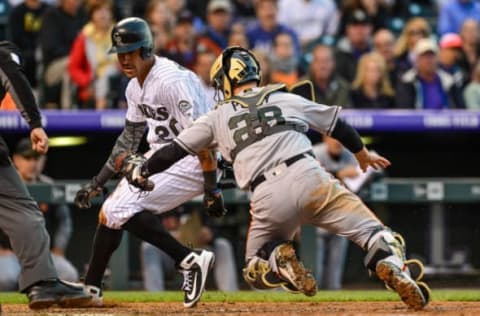 DENVER, CO – MAY 28: Buster Posey #28 of the San Francisco Giants leans to tag Ian Desmond #20 of the Colorado Rockies in the sixth inning of a game at Coors Field on May 28, 2018 in Denver, Colorado. (Photo by Dustin Bradford/Getty Images)