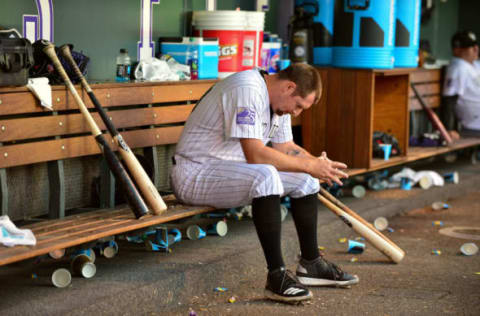 DENVER, CO – JUNE 02: Bryan Shaw #29 of the Colorado Rockies hangs his head in the dugout after being pulled after pitching 1/3 inning and allowing 3 runs in the seventh inning of a game against the Los Angeles Dodgers at Coors Field on June 2, 2018 in Denver, Colorado. (Photo by Dustin Bradford/Getty Images)