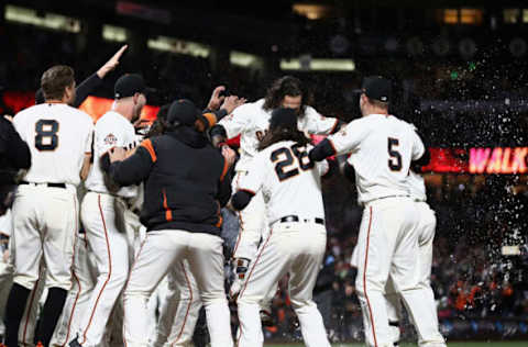 SAN FRANCISCO, CA – JUNE 27: Brandon Crawford #35 of the San Francisco Giants is congratulated by teammates after he hit a walk off home run in the ninth inning to beat the Colorado Rockies at AT&T Park on June 27, 2018 in San Francisco, California. (Photo by Ezra Shaw/Getty Images)