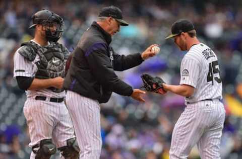 DENVER, CO – JULY 15: Manager Bud Black #10 of the Colorado Rockies hands the ball to Scott Oberg #45 as catcher Chris Iannetta #22 looks on during a pitching change in the eighth inning of a game against the Seattle Mariners at Coors Field on July 15, 2018 in Denver, Colorado. (Photo by Dustin Bradford/Getty Images)