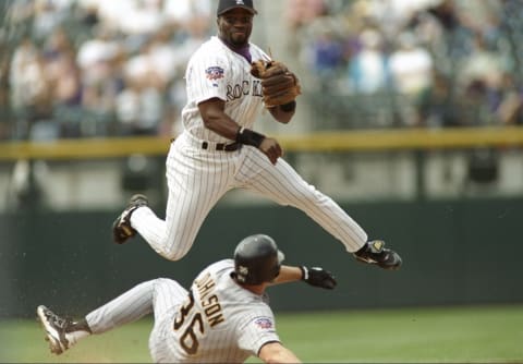 8 May 1997: Second baseman Eric Young of the Colorado Rockies throws the ball as first baseman Mark Johnson of the Pittsburgh Pirates slides into the base at Coors Field in Denver, Colorado. The Pirates won the game 10-8. Mandatory Credit: Brian Bahr/Allsport (Getty).