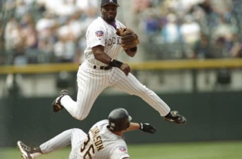 8 May 1997: Second baseman Eric Young of the Colorado Rockies throws the ball as first baseman Mark Johnson of the Pittsburgh Pirates slides into the base at Coors Field in Denver, Colorado. The Pirates won the game 10-8. Mandatory Credit: Brian Bahr /