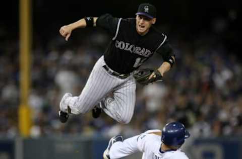 LOS ANGELES, CA – OCTOBER 03: Shortstop Clint Barmes #12 of the Colorado Rockies watches his throw to first to turn the double play as he jumps over James Loney #7 of the Los Angeles Dodgers on October 3, 2009 at Dodger Stadium in Los Angeles, California. The Dodgers won 5-0 to clinch the National League West. (Photo by Stephen Dunn/Getty Images)