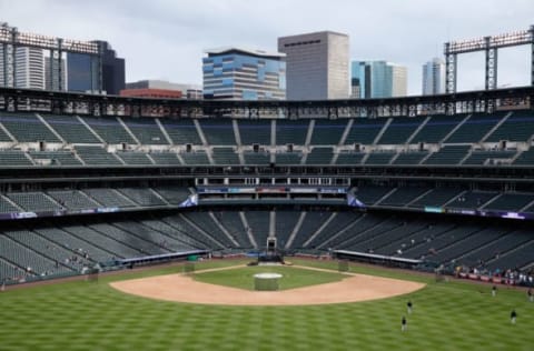 DENVER, CO – APRIL 25: The Denver skyline provides a backdrop for the ballpark as the field is prepared for the Pittsburgh Pirates to face the Colorado Rockies at Coors Field on April 25, 2016 in Denver, Colorado. The Pirates defeated the Rockies 6-1. (Photo by Doug Pensinger/Getty Images)