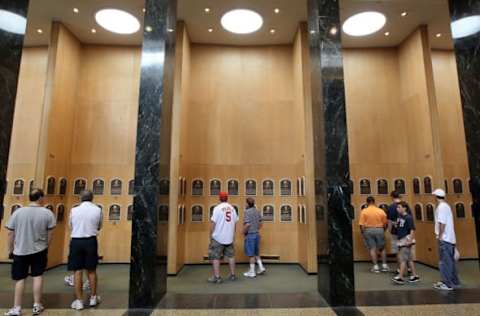 COOPERSTOWN, NY – JULY 24: Patrons of the Baseball Hall of Fame and Museum view the plaques of inducted members during induction weekend on July 24, 2010 in Cooperstown, New York. (Photo by Jim McIsaac/Getty Images)