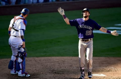 LOS ANGELES, CA – SEPTEMBER 25: David Dahl #26 of the Colorado Rockies celebrates his solo homerun in front of Yasmani Grandal #9 of the Los Angeles Dodgers to take a 3-2 lead during the ninth inning at Dodger Stadium on September 25, 2016 in Los Angeles, California. (Photo by Harry How/Getty Images)